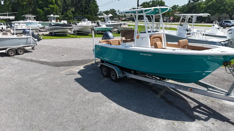 Slide: The Image of 2022 Sea Hunt 229 ULTRA boat on trailer in a marina parking lot. - 13