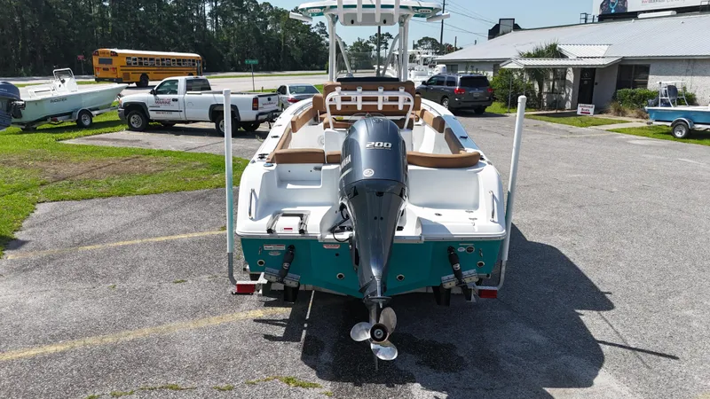 Slide: The Image of 2022 Sea Hunt 229 ULTRA boat with outboard motor, parked in a lot. - 14