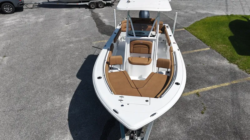 Slide: The Image of 2022 Sea Hunt 229 ULTRA boat with brown seating, parked on pavement. - 5