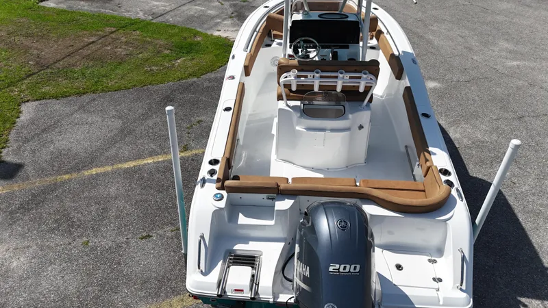 Slide: The Image of 2022 Sea Hunt 229 ULTRA boat with Yamaha 200 engine, parked on pavement. - 7