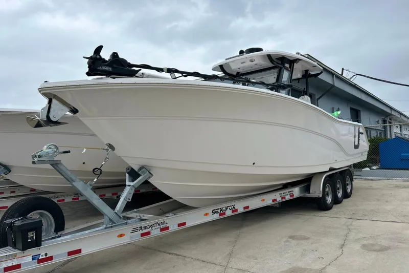 The Image of 2025 Sea Fox 328 Commander boat on trailer, parked outdoors. - 0