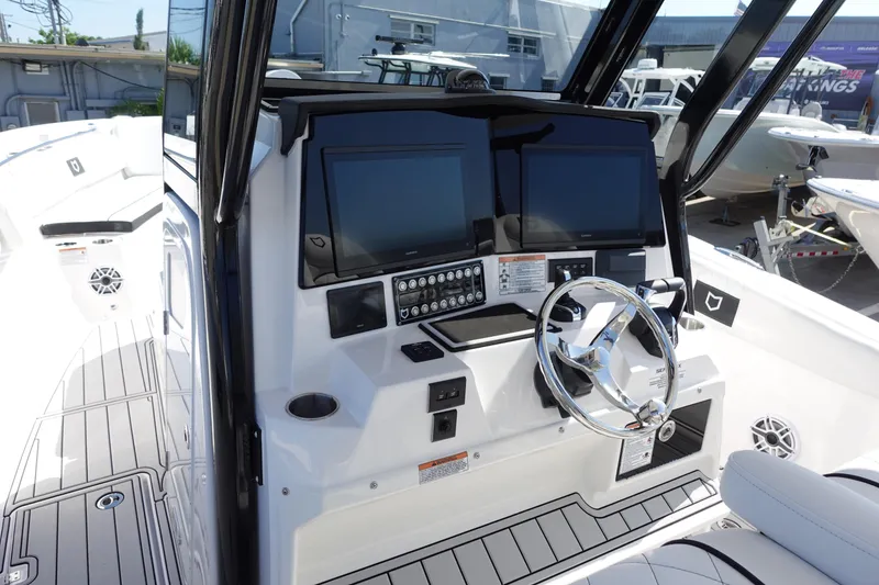 Slide: The Image of Control panel of 2025 Sea Fox 328 Commander boat with joystick and buttons. - 2