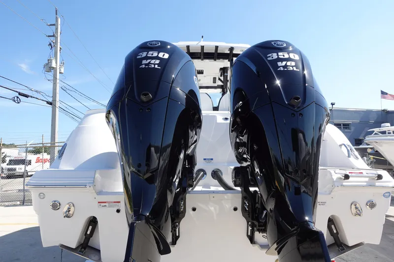 Slide: The Image of 2025 Sea Fox 328 Commander boat with sunshade and seating, parked outdoors. - 42