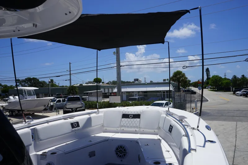Slide: The Image of 2025 Sea Fox 328 Commander boat docked at marina with clear blue sky. - 46