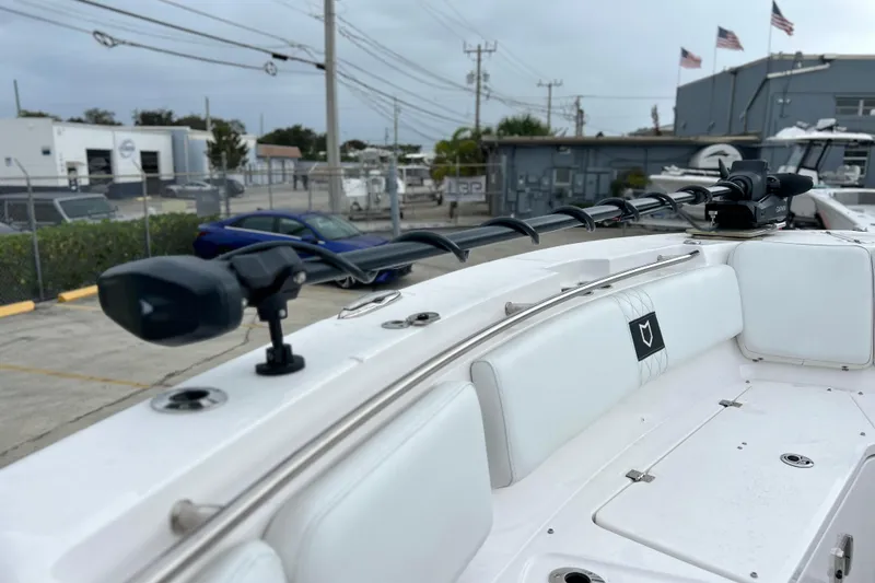 Slide: The Image of 2025 Sea Fox 328 Commander boat interior with white seating and mounted equipment. - 55