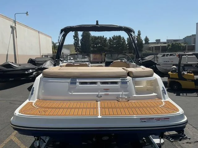 Slide: The Image of 2025 Bayliner VR5 Bowrider I/O with teak swim platform, parked outdoors. - 10