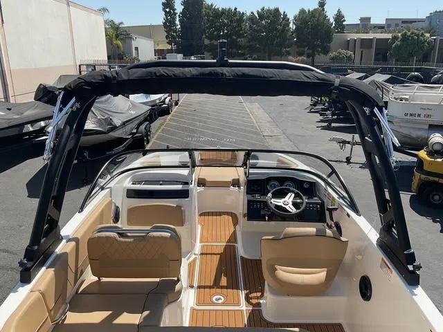 Slide: The Image of 2025 Bayliner VR5 Bowrider I/O with tan interior and sleek design, parked outdoors. - 12