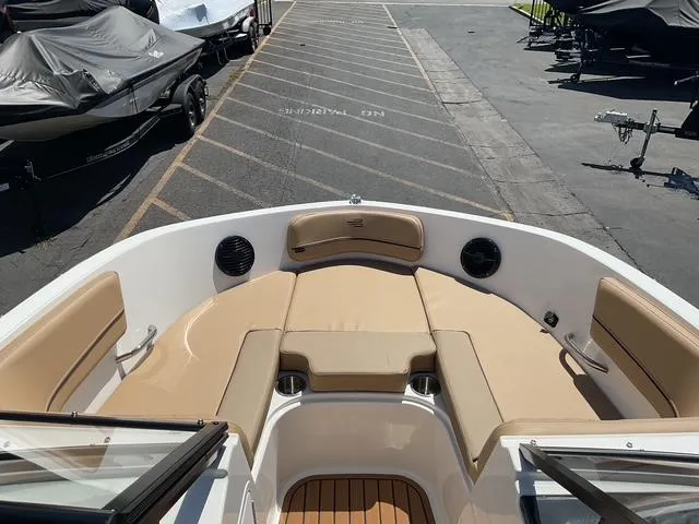 Slide: The Image of 2025 Bayliner VR5 Bowrider I/O with tan seating, docked in a marina. - 15