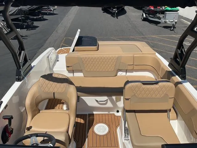 Slide: The Image of 2025 Bayliner VR5 Bowrider I/O interior with tan seating and wood accents. - 16