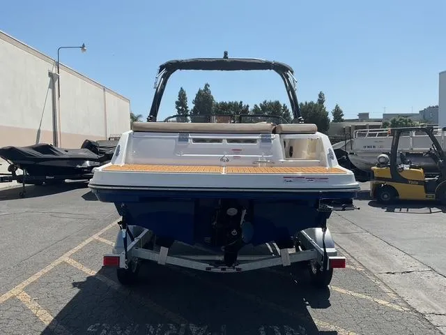 Slide: The Image of 2025 Bayliner VR5 Bowrider I/O boat, rear view, parked outdoors on a sunny day. - 2