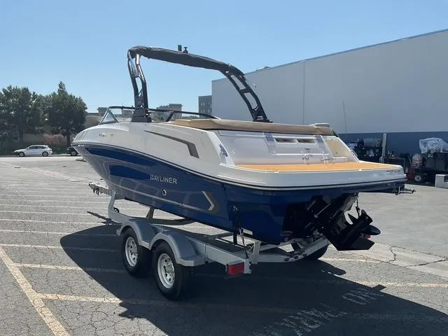 Slide: The Image of 2025 Bayliner VR5 Bowrider I/O on trailer, parked outdoors, rear view. - 3