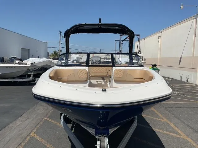 Slide: The Image of 2025 Bayliner VR5 Bowrider I/O boat in a parking lot, front view. - 8