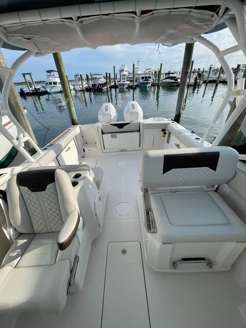 Slide: The Image of 2021 Sailfish 276 DC boat interior with seating, docked at marina. - 15