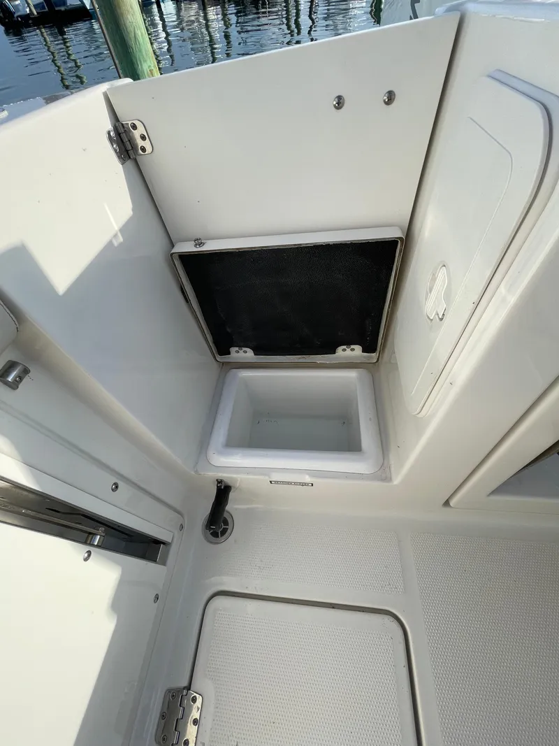 Slide: The Image of 2021 Sailfish 276 DC boat interior storage compartment with open hatch. - 22