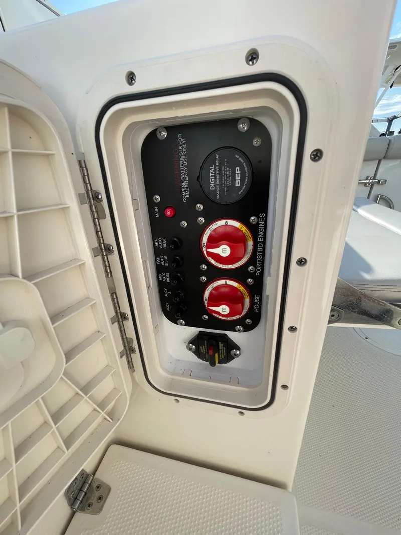 Slide: The Image of Control panel on a 2021 Sailfish 276 DC boat, featuring switches and dials. - 24