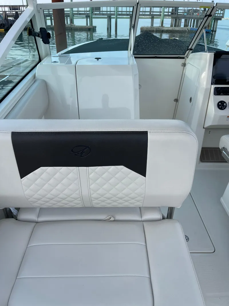 Slide: The Image of 2021 Sailfish 276 DC boat interior with white seating and modern design. - 31