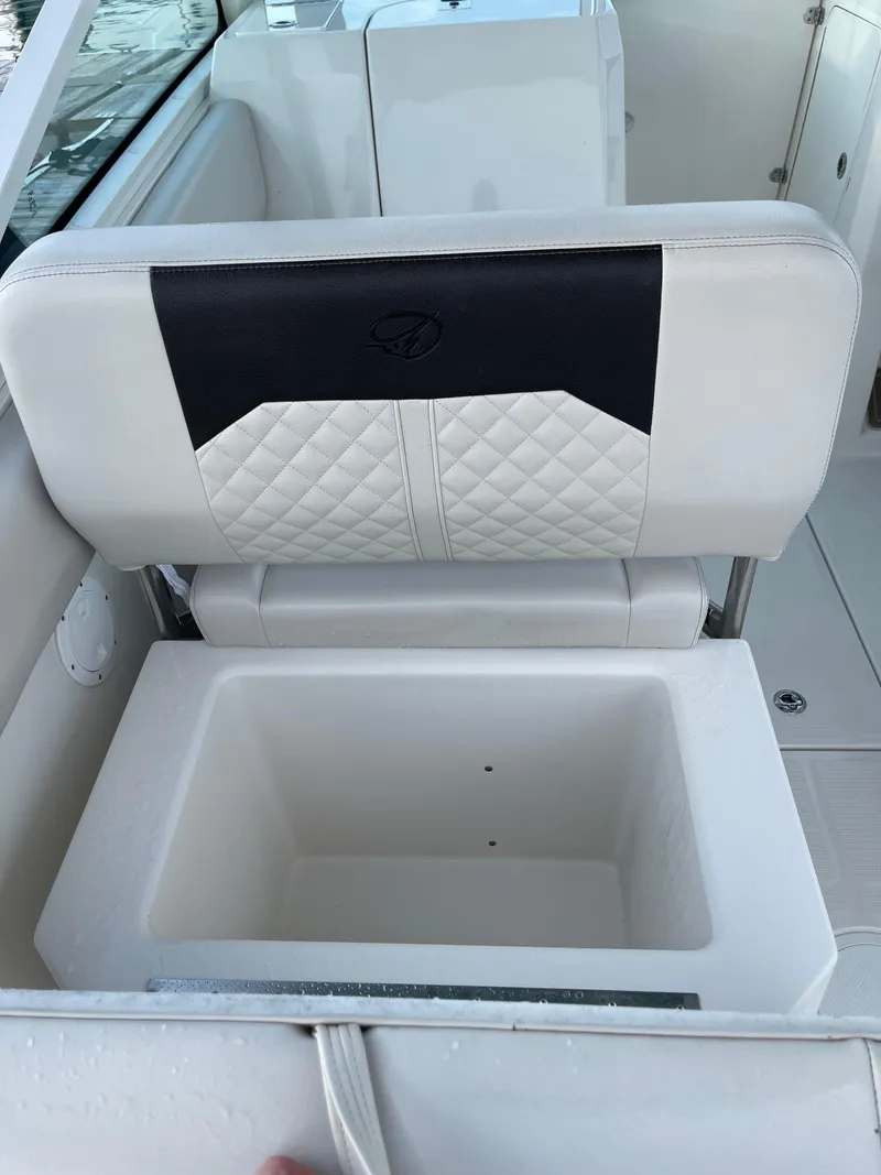 Slide: The Image of 2021 Sailfish 276 DC boat seat with integrated storage compartment. - 34