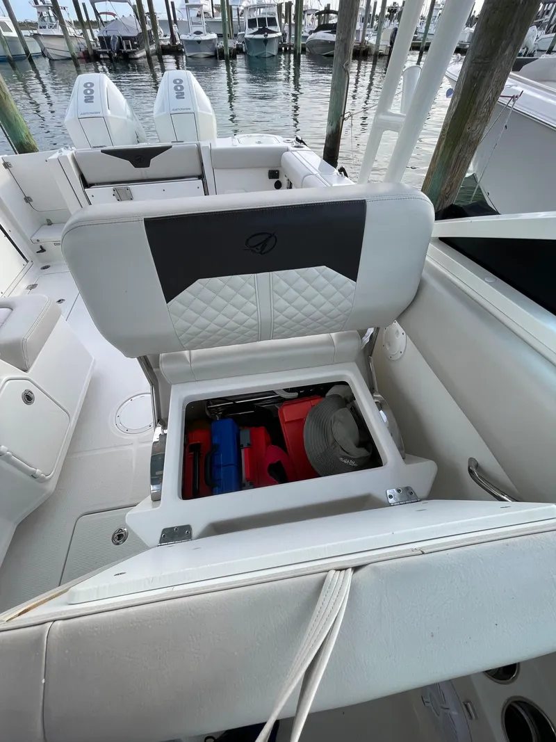 Slide: The Image of 2021 Sailfish 276 DC boat with open storage compartment, docked at marina. - 38