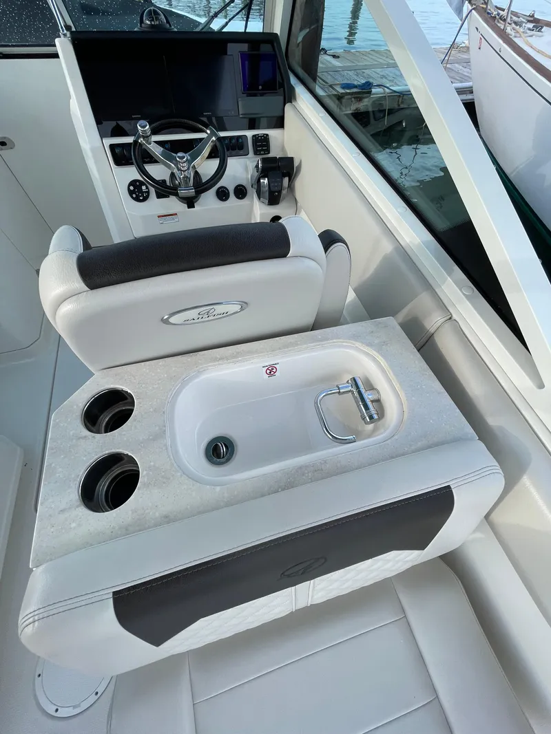 Slide: The Image of 2021 Sailfish 276 DC boat interior with steering console and seating area. - 39