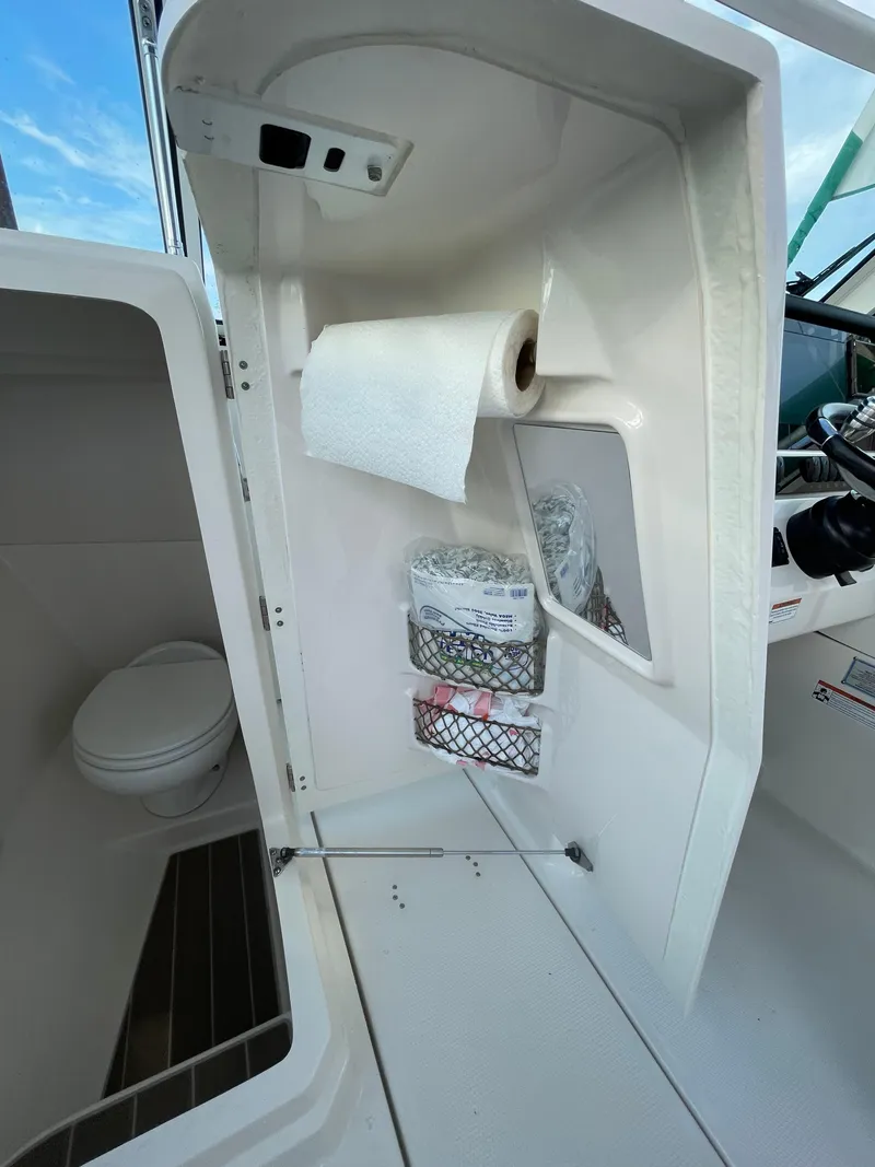 Slide: The Image of 2021 Sailfish 276 DC boat interior with toilet and storage compartments. - 42