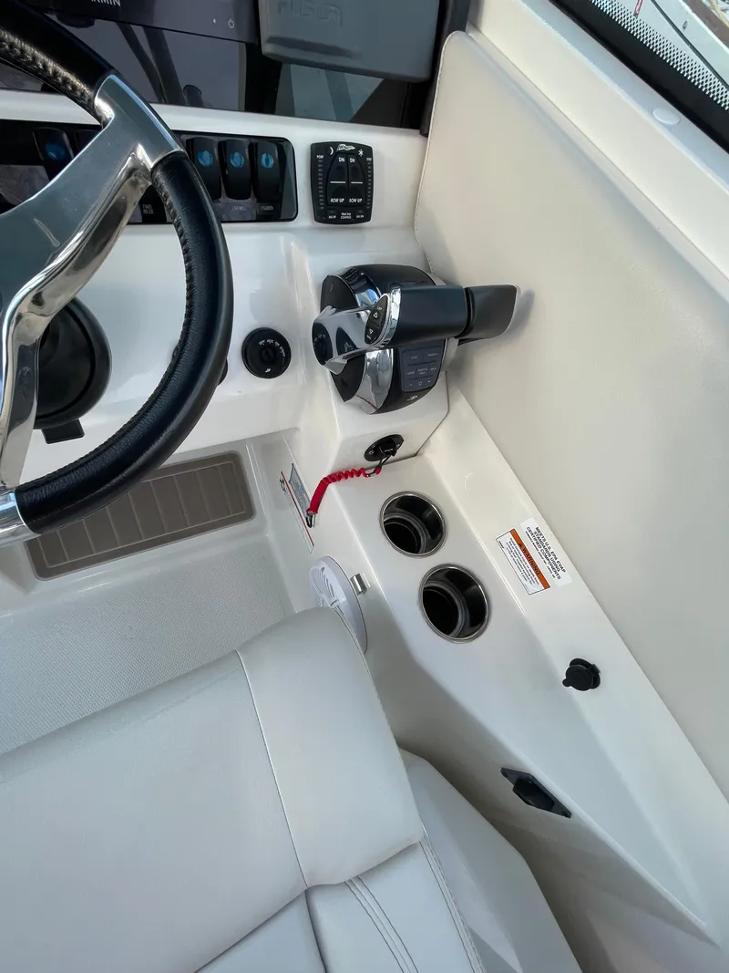 Slide: The Image of 2021 Sailfish 276 DC boat helm with steering wheel and controls. - 48