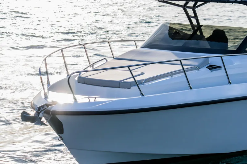 The Image of 2025 Oryx 32 FX boat on water, sleek design, sunlit deck, modern features. - 2