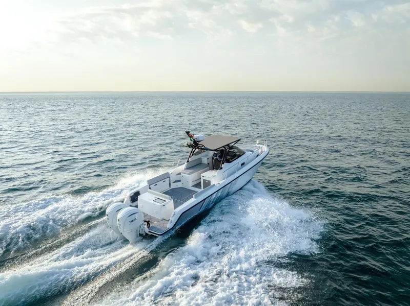 Slide: The Image of 2025 Oryx 32 FX boat cruising on open sea under clear sky. - 4