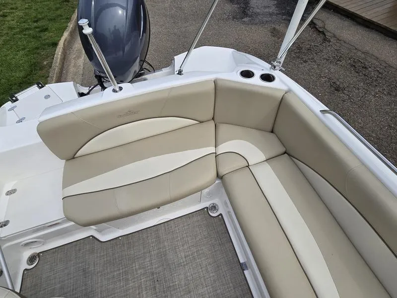 Slide: The Image of 2021 NauticStar 193 SC boat interior with beige seating and cup holders. - 10