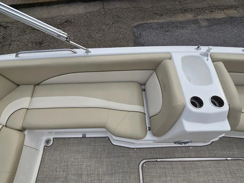 Slide: The Image of 2021 NauticStar 193 SC boat interior with beige seating and cup holders. - 11