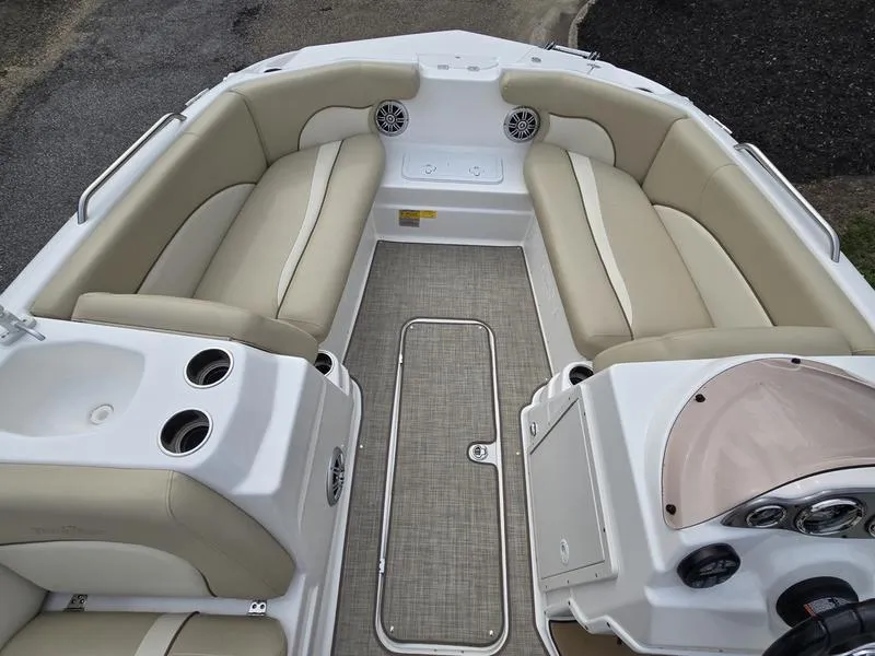 Slide: The Image of 2021 NauticStar 193 SC boat interior with beige seating and modern dashboard. - 12