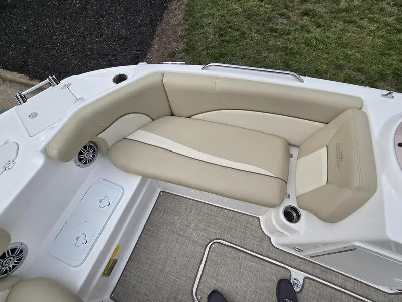 Slide: The Image of 2021 NauticStar 193 SC boat interior with beige seating and cup holders. - 13