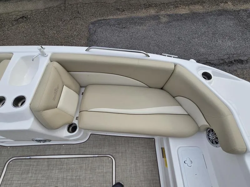 Slide: The Image of 2021 NauticStar 193 SC boat interior with beige seating and cup holders. - 14