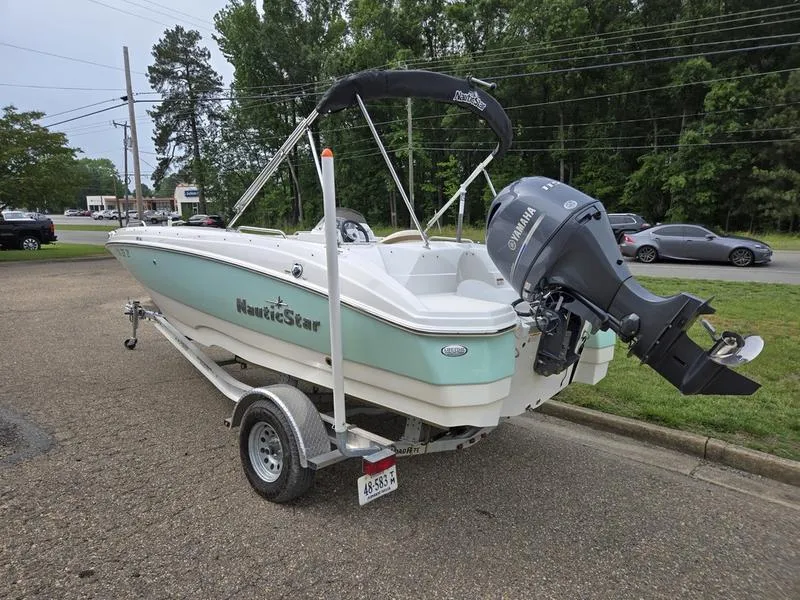 Slide: The Image of 2021 NauticStar 193 SC boat on trailer with Yamaha outboard motor, parked outdoors. - 3