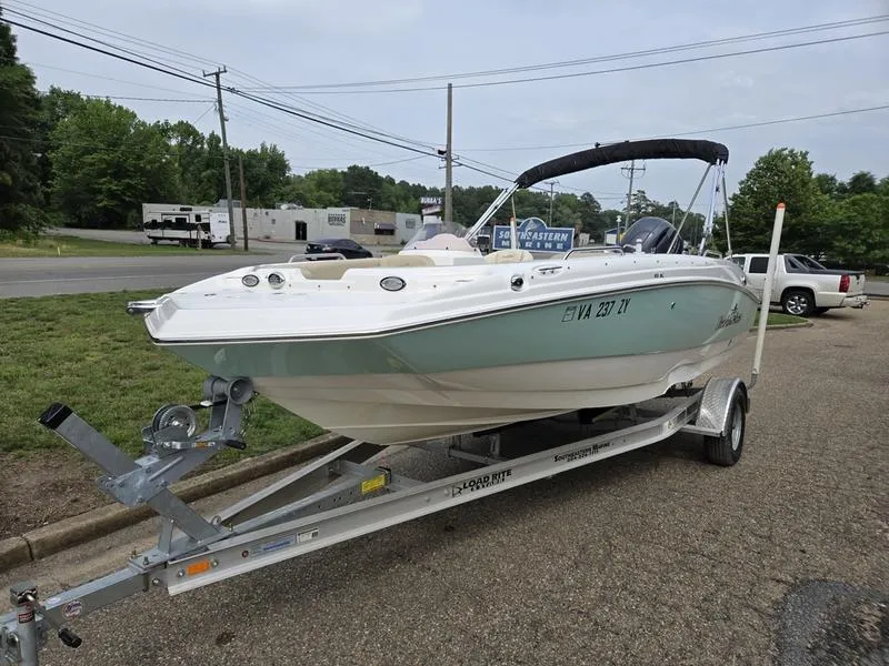 Slide: The Image of 2021 NauticStar 193 SC boat on trailer, parked outdoors. - 4