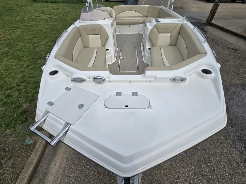 Slide: The Image of 2021 NauticStar 193 SC boat with beige seating and white deck, parked on pavement. - 6