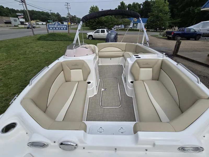 Slide: The Image of 2021 NauticStar 193 SC boat interior with beige seating and spacious layout. - 7
