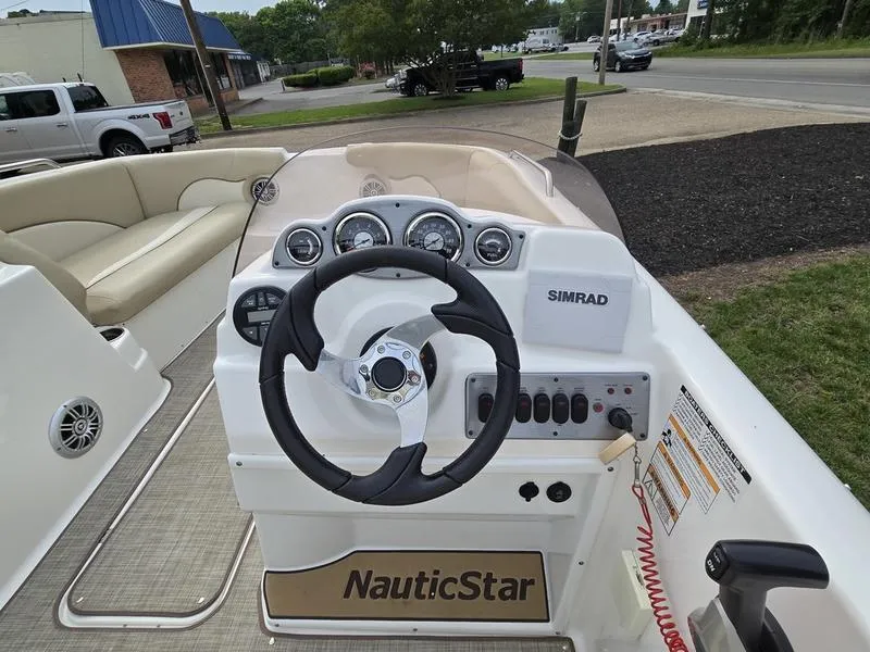 Slide: The Image of 2021 NauticStar 193 SC boat dashboard with steering wheel and Simrad display. - 8