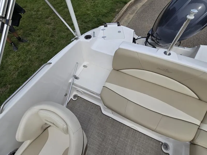 Slide: The Image of 2021 NauticStar 193 SC boat interior with beige seating and carpeted floor. - 9