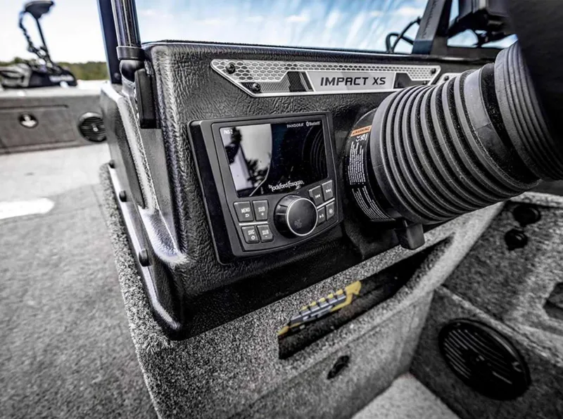 Slide: The Image of 2026 Lund 1875 Impact XS boat dashboard with control panel and speaker system. - 12