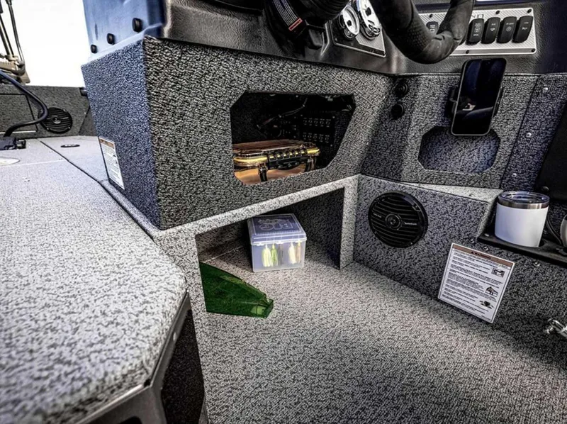 Slide: The Image of Interior view of 2026 Lund 1875 Impact XS boat cockpit with storage compartments. - 13