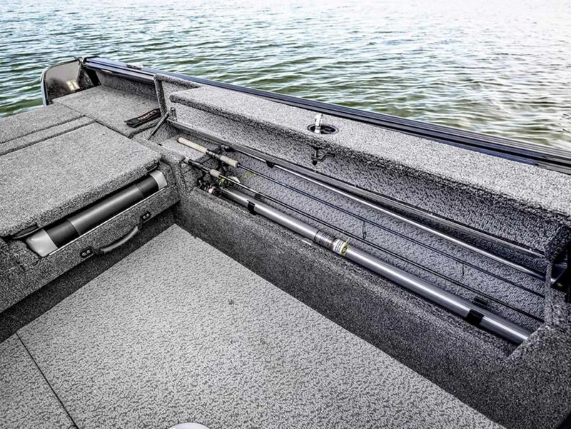 Slide: The Image of 2026 Lund 1875 Impact XS boat interior with rod storage, on calm water. - 18
