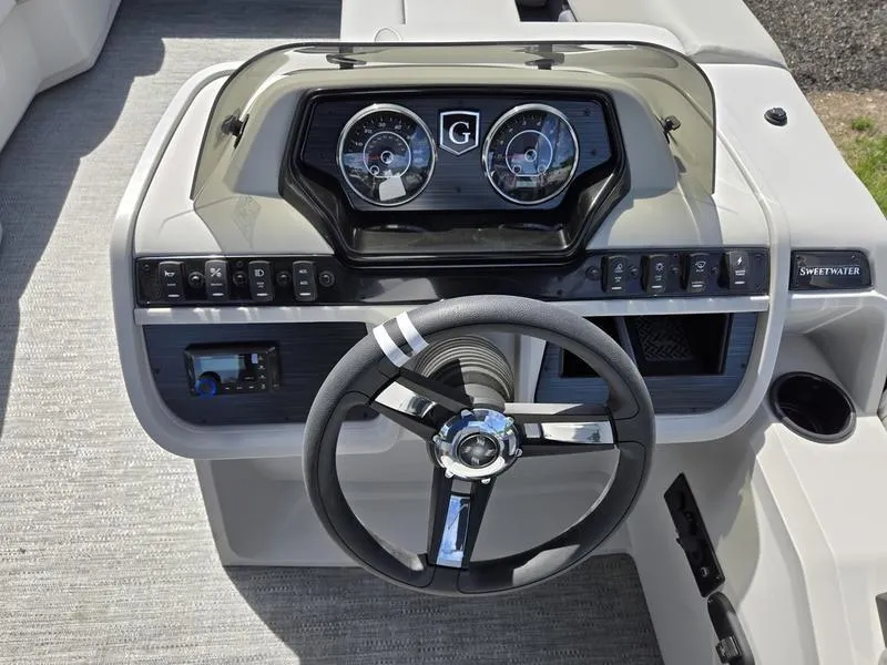 Slide: The Image of Steering console of 2025 Godfrey Sweetwater 2086 C boat with modern controls and gauges. - 10