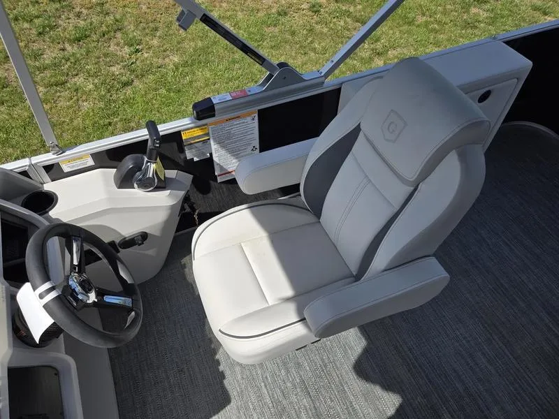 Slide: The Image of Captain's chair and helm of 2025 Godfrey Sweetwater 2086 C pontoon boat. - 11