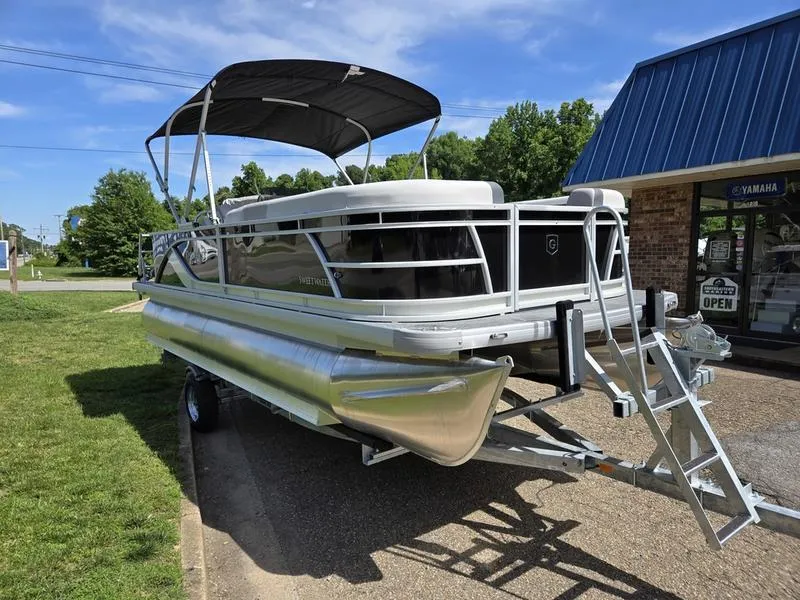Slide: The Image of 2025 Godfrey Sweetwater 2086 C pontoon boat on trailer, parked outdoors near a building. - 3