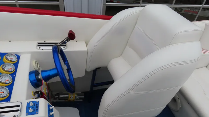 Slide: The Image of Interior of a 2004 Cigarette 42 Tiger boat with white seating and blue steering wheel. - 10