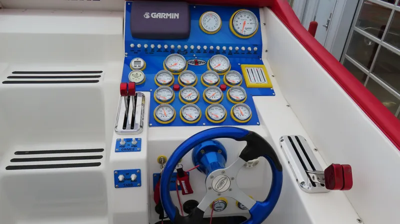 Slide: The Image of Dashboard of a 2004 Cigarette 42 Tiger boat with gauges and Garmin equipment. - 11