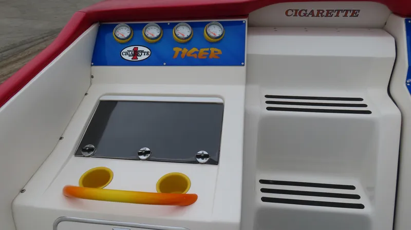 Slide: The Image of 2004 Cigarette 42 Tiger boat dashboard with gauges and branding. - 12