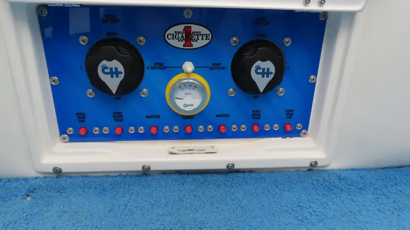 Slide: The Image of Control panel of a 2004 Cigarette 42 Tiger boat with gauges and switches. - 13