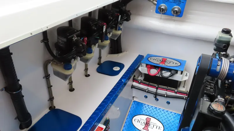 Slide: The Image of Engine compartment of a 2004 Cigarette 42 Tiger boat, showcasing mechanical components and branding. - 15