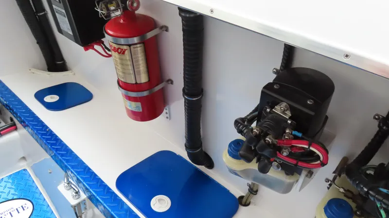 Slide: The Image of Engine compartment of 2004 Cigarette 42 Tiger boat with fire extinguisher and mechanical components. - 16